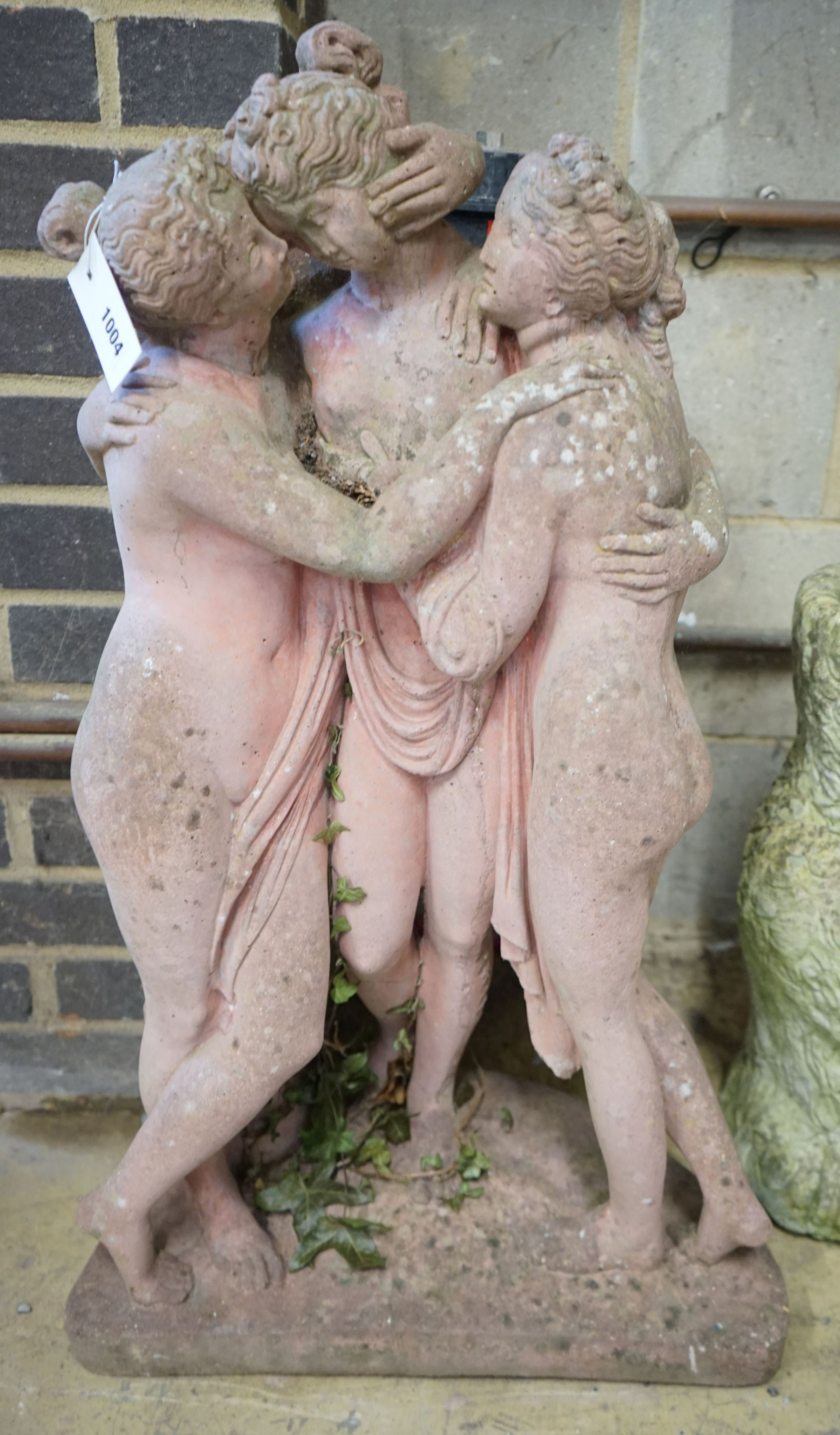 A reconstituted stone faux terracotta 'Three Graces' garden statue, height 75cm